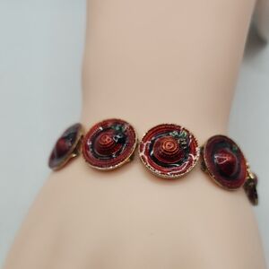 Elegant Red and Gold Featuring Red Hats With Green Plant Accents Bracelet
